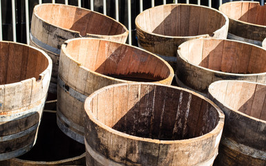 Old wooden half barrels. Ex wine casks having a second life to be used as decoration or as a flower...