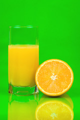 Obraz na płótnie Canvas orange juice on a green background