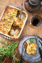 English shepherds pie as top-view on a pewter plate and backing dish