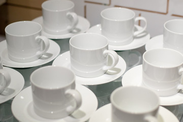 White ceramic cups set on display