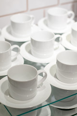 White ceramic cups set on display