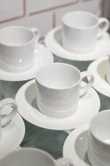 White ceramic cups set on display