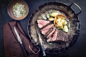  Barbecue boar neck with fried potatoes as top view in a frying pan © HLPhoto