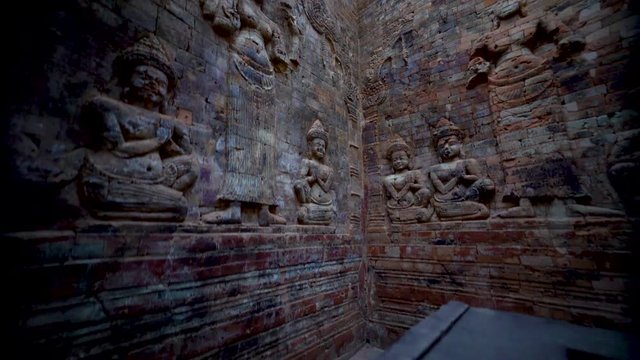Boom down showing the full length of the interior walls of Prasat Kravan&rsquo;s northernmost tower feature a pair of bas-reliefs of Lakshmi, Vishnu's consort, flanked by devotees