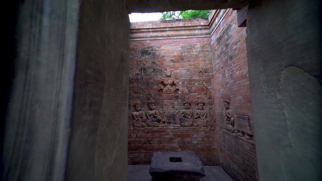 Boom down on exterior and and entering Prasat Kravan&rsquo;s northernmost tower featuring a pair of bas-reliefs of Lakshmi, Vishnu's consort, flanked by devotees