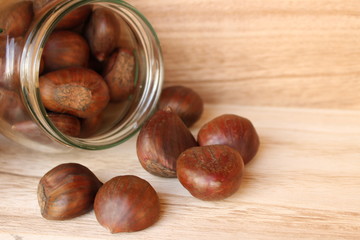 Chestnut on old wooden table close up with copy space. Top view. Autumn background, outdoor shoot