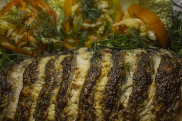 Stuffed carp, decorated with vegetables. Fish dish.