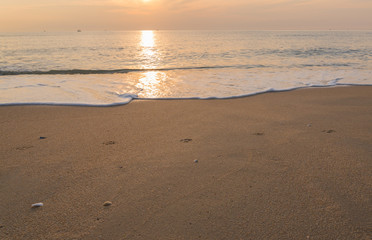 Sunset over the sea and beautiful sand beach