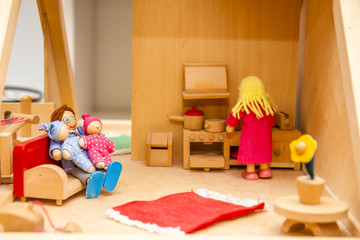 Closeup of wooden dollhouse family