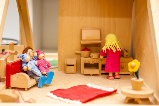 Closeup of wooden dollhouse family