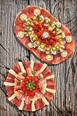 Fototapeta na wymiar Two Traditional Serbian Welcome Appetizer Savory Dishes Meze Set On Rustic Old Weathered Cracked Pinewood Picnic Table Grunge Surface