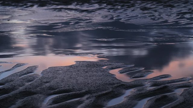 pastel moving clouds reflection on the beach TIMELAPSE