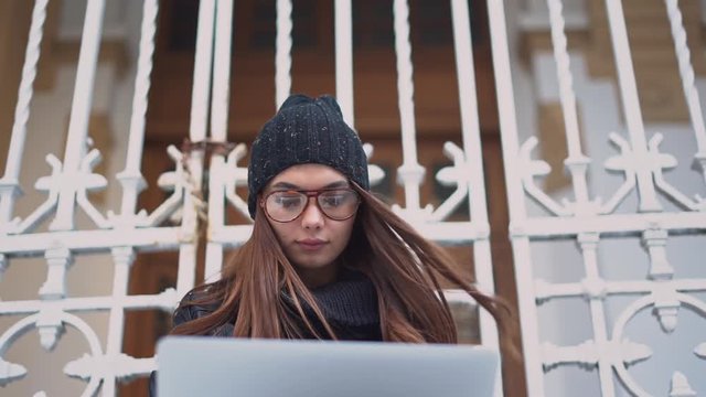 Young woman, using her computer outside