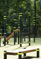 Fototapeta premium Street sports ground. The horizontal bar and benches