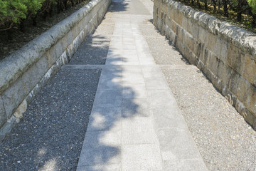 Gray background with paved walkway in Japanese park in Kyoto, Japan