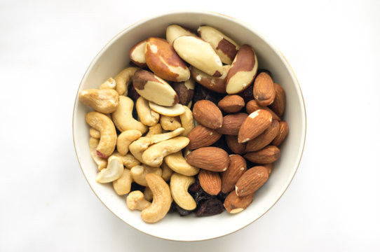 Bowl of mixed nuts (Brazil nuts, cashews and almonds) in a little bowl on the white background
