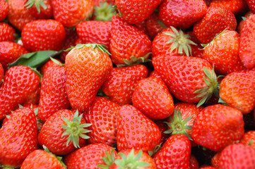 Fresh strawberry macro close up as background.
