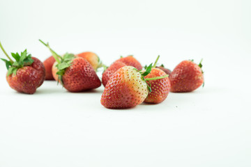 Close up of the strawberries on the white background.