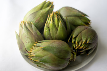 Fototapeta premium Five artichokes on the white background