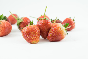 Close up of the strawberries on the white background.