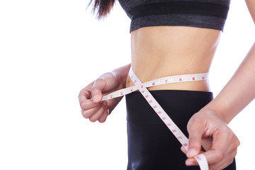 close up woman measuring waist with tape isolated on white