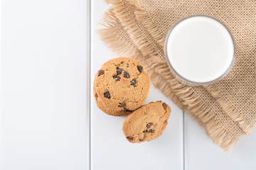 Top view of milk and chocolate biscuit on table