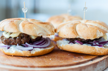 Home made burger on a wooden chopping board