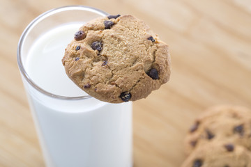 Closeup of chocolate biscuit on a cup of milk