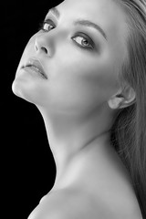 Monochrome closeup beauty portrait of young beautiful woman with long straight hair with natural makeup. Hairstyle, skincare and cosmetics concept