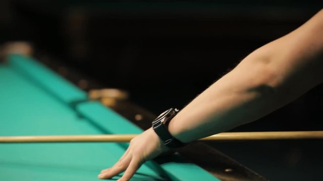 Billiards, concentrated young man playing in club