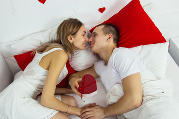Valentines day bed lovely caucasian couple celebration red lay down