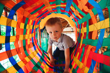 Boy playing on the playground, in the children's maze.