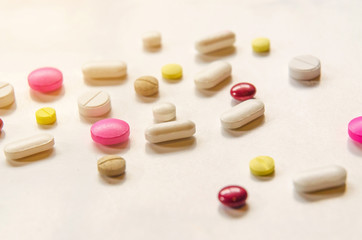 Close-up of the pills on the white background, The drug and capsule pills on the floor, Pile of the drug and pills on the white background.