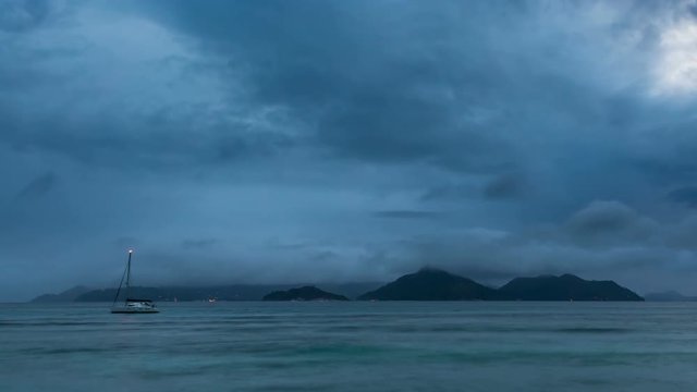 Zooming timelapse sequence of Praslin seen from La Digue, Seychelles at sunset with changing weather and light in 4K