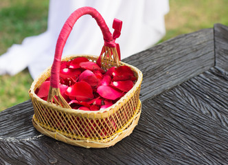 Red rose petals in bamboo basket