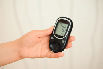 glucometer with result of measurement sugar level and tape measure, concept of diabetes