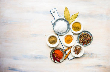 Different spices on white wooden table