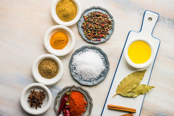 Different spices on white wooden table