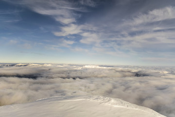 peaks of mountains above the clouds