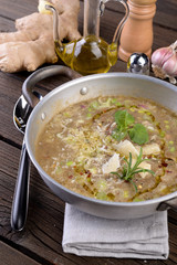 Saucepan with vegetable and cereal soup