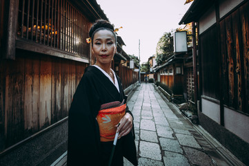 Beautiful japanese senior woman walking in the village. Typical japanese traditional lifestyle