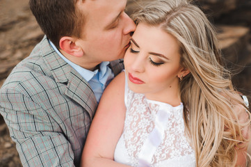 Fototapeta premium Love, romance and people concept - happy young couple hugging