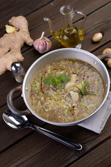 Saucepan with vegetable and cereal soup