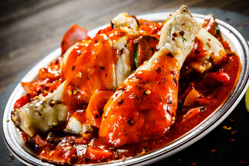 Boiled chicken drumsticks with tomato sauce