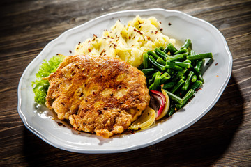 Fried pork chop, mashed potatoes and green beans