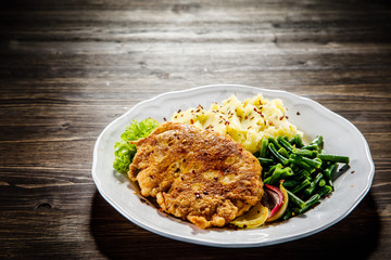 Fried pork chop, mashed potatoes and green beans
