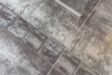 Bathroom floor metallic design tiles