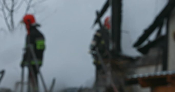 Firefighter or fireman fiting with fire on home.