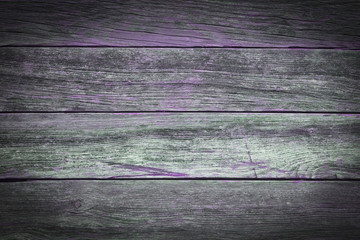 A rustic wooden background made of weathered boards with purple details