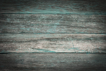 A rustic wooden background made of weathered boards with turquoise details